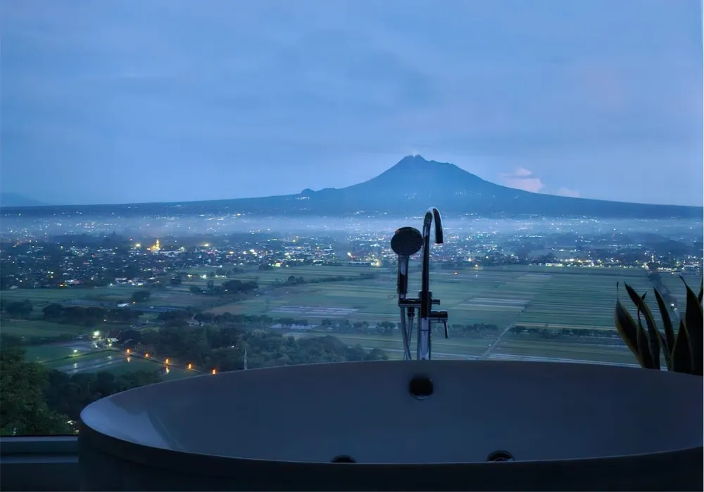 The Prambanan area seen from the luxury hotel Amaranta atop Boko Hill, with Prambanan Temple and Mount Merapi